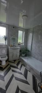 a bathroom with a tub and a toilet and a sink at Eighteen in Jesmond