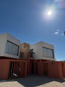 a large house with a red and white at Vilaggio Magnolia in Cafayate