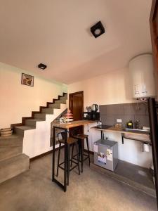 a kitchen with a counter and a staircase at Vilaggio Magnolia in Cafayate