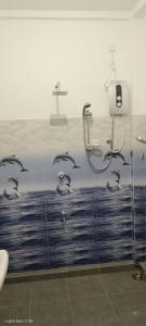 a bathroom with a wall with birds on it at Ocean & Beach kite Hotel in Kalpitiya +53 photos