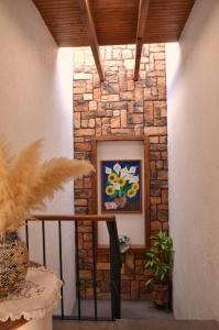 a stone wall with a painting on a wall at Great location 5min from the center,10fromVINEYARD in Tequisquiapan