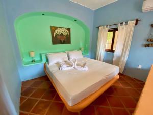a bedroom with a bed with two ducks on it at Casa MoJo - Whole house 7BR, heated pool, WiFi in Sayulita