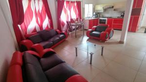 a living room with a couch and chairs and a table at Ecotropicfarmhouse in Cerro Azul