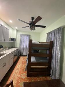 a kitchen with a ceiling fan and a kitchen counter at Must-See Okemo Mountain Resort in Springfield