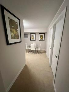 a hallway with a dining room with a table and chairs at Basement with 2 rooms in Ottawa