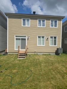 a house with a hose in the yard at Basement with 2 rooms in Ottawa
