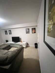 a living room with a couch and a table at Basement with 2 rooms in Ottawa
