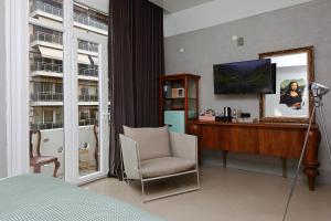 a bedroom with a desk and a chair and a mirror at Paradox in Thessaloniki
