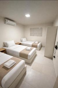 a hotel room with two beds and a room with two beds at Casa Canto do Mar in Maragogi