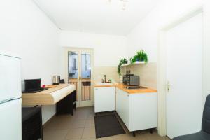 a kitchen with a sink and a desk in a room at Piazza Grande House in Locarno