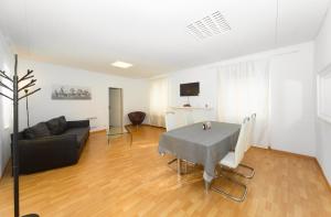 a living room with a table and a couch at Piazza Grande House in Locarno