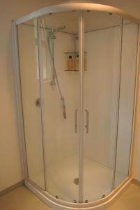 a shower with a glass enclosure in a room at Hill Top Hideaway - Self Contained Guest Suite with Private Spa in Pukerua Bay +16 photos