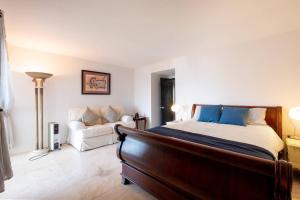 a bedroom with a bed and a couch at Playa Blanca Condo in Tijuana +14 photos