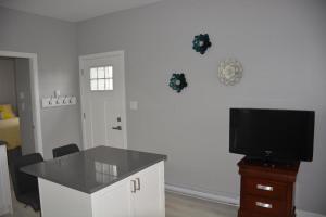 a living room with a table and a television at Location, Location, Location-Immaculate 1 Bedroom Suite in Victoria