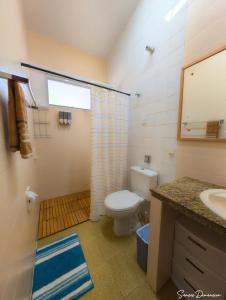 a bathroom with a toilet and a sink at Senses Dimension - Ipioca Beach Suites in Maceió