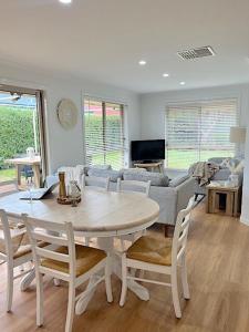 a living room with a table and chairs and a couch at Coastal Calm in Normanville