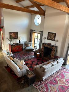 a living room with couches and a fireplace at Big Red Barn - Spectacular Villa in Sancheira
