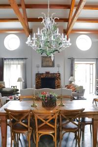 a dining room with a table and a chandelier at Big Red Barn - Spectacular Villa in Sancheira