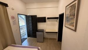 a room with a bed and a desk in it at Serenade Hotel in Placencia