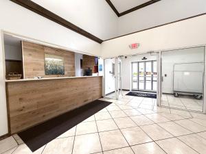 a large room with a counter and a tv at Americas Best Value Inn Wiggins in Wiggins