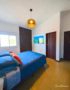 a bedroom with a blue bed and a window at Senses Dimension - Ipioca Beach Suites in Maceió +7 photos