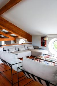 a living room with white furniture and a vaulted ceilings at Big Red Barn - Spectacular Villa in Sancheira
