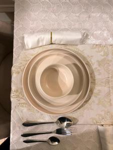 a plate on a table with a fork and knife at Designer 1 bedroom , self check-in , pool & sauna in Rawalpindi +20 photos