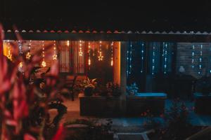 a patio with christmas lights and plants in a yard at Chalet Alto Bonito in Pueblorrico +67 photos