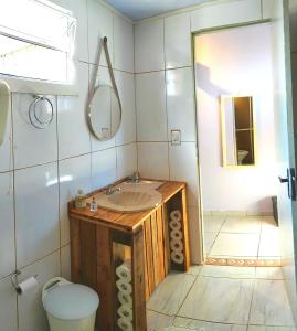a bathroom with a sink and a toilet at Casa Recanto do Baiano in Balneário Gaivotas