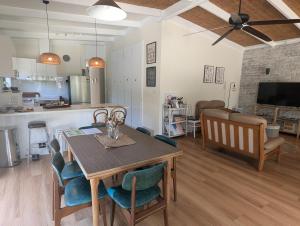 a kitchen and living room with a table and chairs at Cosy Brick Beachouse - ALL INCLUDED in Inverloch +35 photos