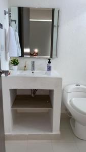 a white bathroom with a sink and a toilet at Casa HOTEL campestre TranKilandia in Rivera
