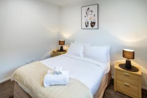 a bedroom with a bed with two towels on it at Spacious 3BR with 2 carpark in Lincoln