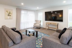 a living room with two couches and a tv at Spacious 3BR with 2 carpark in Lincoln