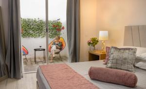 a woman sitting in a chair in a bedroom at Santuario De Luna, Departamento in Cholula