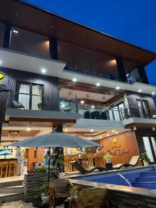 a large house with a swimming pool and an umbrella at Casa Rubio private Resort in Los Baños