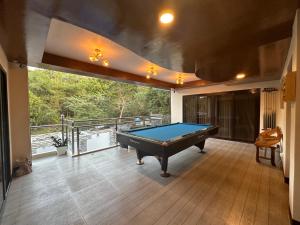 a pool table in a room with a balcony at Casa Rubio private Resort in Los Baños