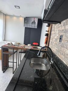 a kitchen with a sink and a counter top at Chalé Refugio nas montanhas in Guaratuba +47 photos