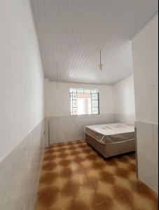 a bedroom with a bed in the middle of a room at Recanto Sossego I in Tucano