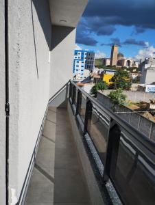 a balcony of a building with a view of a city at Hotel Pousa Vale Imperial in Aparecida