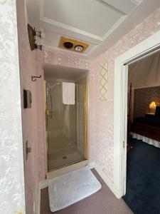 a bathroom with a shower with a glass door at Shaw House Inn in Ferndale