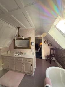a bathroom with a sink and a mirror and a tub at Shaw House Inn in Ferndale +30 photos