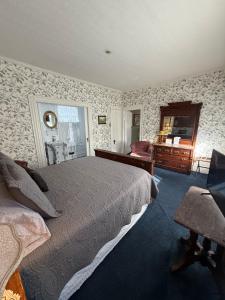 a bedroom with a bed and a dresser in it at Shaw House Inn in Ferndale