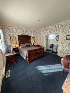 a bedroom with a bed and a desk with a computer at Shaw House Inn in Ferndale