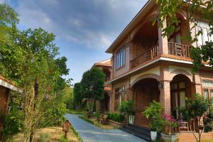 a brick building with a walkway in front of it at Phi Yen Eco Resort Can Tho in Can Tho
