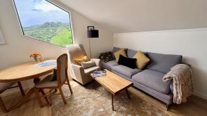 una sala de estar con un sofá y una mesa en Fantail Hill, en Thames