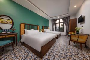 En eller flere senge i et værelse på Tam Coc Condelux Boutique Hotel