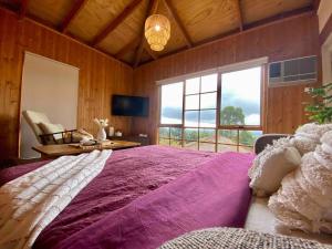 a large bed in a room with a large window at Mountain View Spa Cottage in The Basin