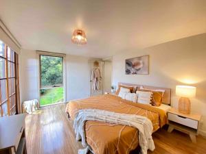 a bedroom with two beds and a large window at Mountain View Spa Cottage in The Basin +41 photos