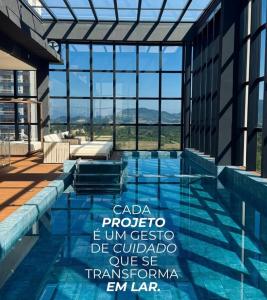 a swimming pool with a view of a building at Flat novo próximo ao Hard Rock in Itapema