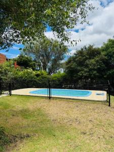 a fence around a swimming pool in a yard at Merlinda in Merlo